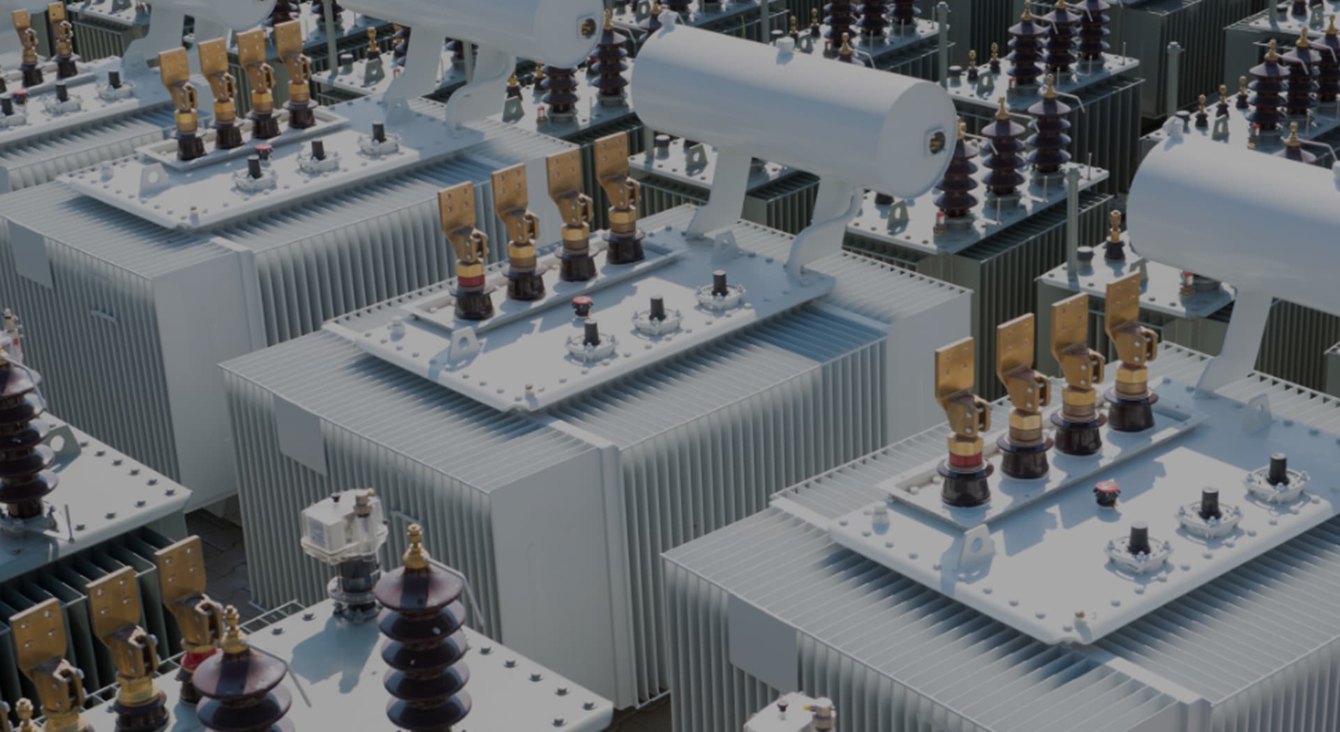 Rows of distribution transformers with bushings and conservators